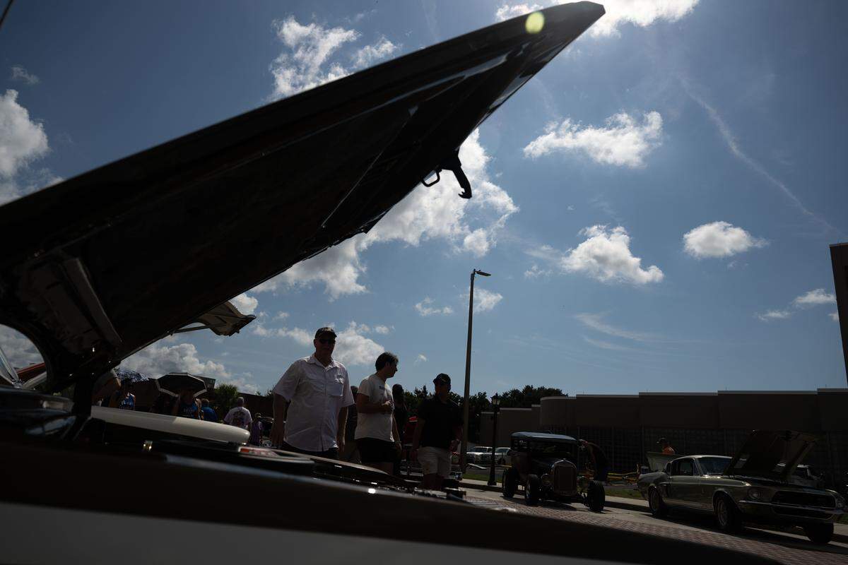 Event attendees check out cars Wednesday at the Biloxi Block Party.