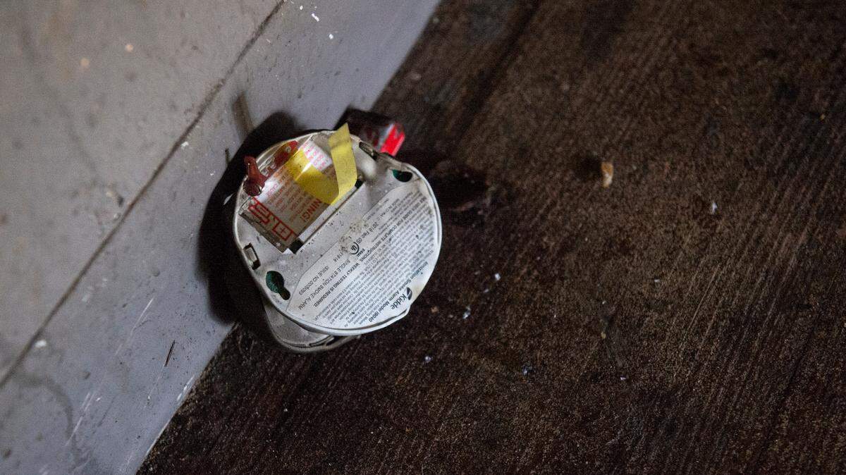 A burnt smoke detector in the stairwell of the the building of the William Bell Apartments in Gulfport where a fire killed two on Jan. 25, 2023.