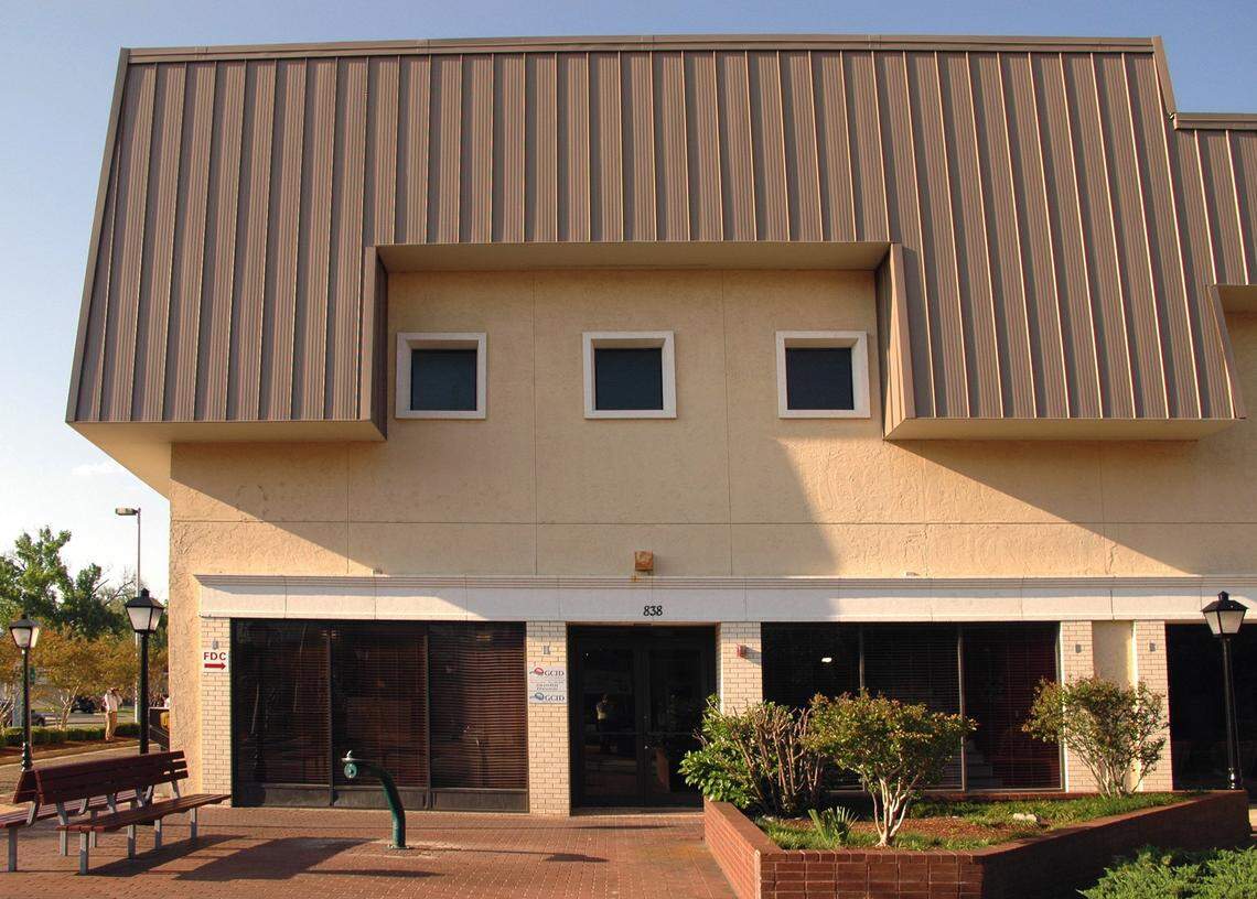 The Urban Renewal facade of the Barq building on Howard Avenue in Biloxi is gone, revealing the brick storefronts and apartments in the next phase of The District on Howard mixed use project.