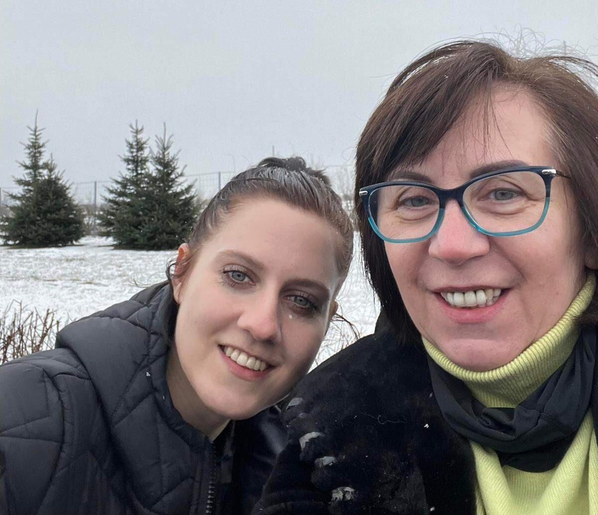Family friend Kaluida Czerwonka-Kmiotczyk (left) waits with Antonina Godfrey near the Poland and Ukraine border after volunteering to drive the family to pick up Antonina’s mother. “She did not ask for money however we did give her some. She said money will go to charity,” said Godfrey.