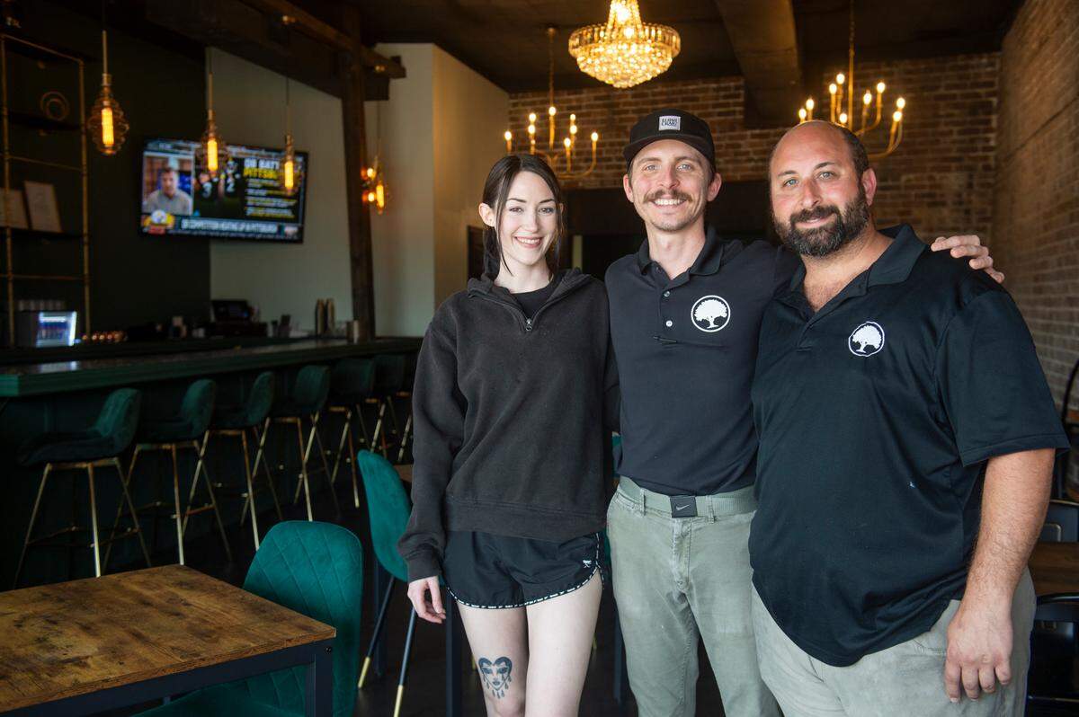 Owner Greg Schwartz, right, server Brianna Cleary, left, and general manager Joey Debenport welcome diners the first day at Lazy Oak Brunch + Bistreaux in Gulfport.