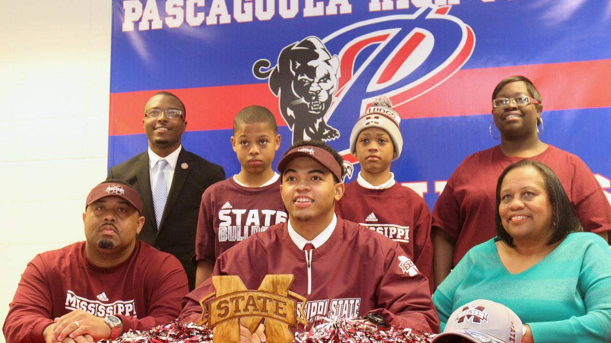 JOHN FITZHUGH/SUN HERALDPascagoula High School's Keith Joseph Jr. poses with his family for National Signing Day photos on Wednesday Feb. 4, 2015. Joseph and his father, Keith Joseph Sr., were killed in a car accident in Greene County on Friday.