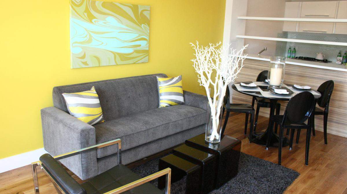 TNSA black acrylic coffee table and dining chairs provide a sense of opacity while also appearing light and modern in the space.