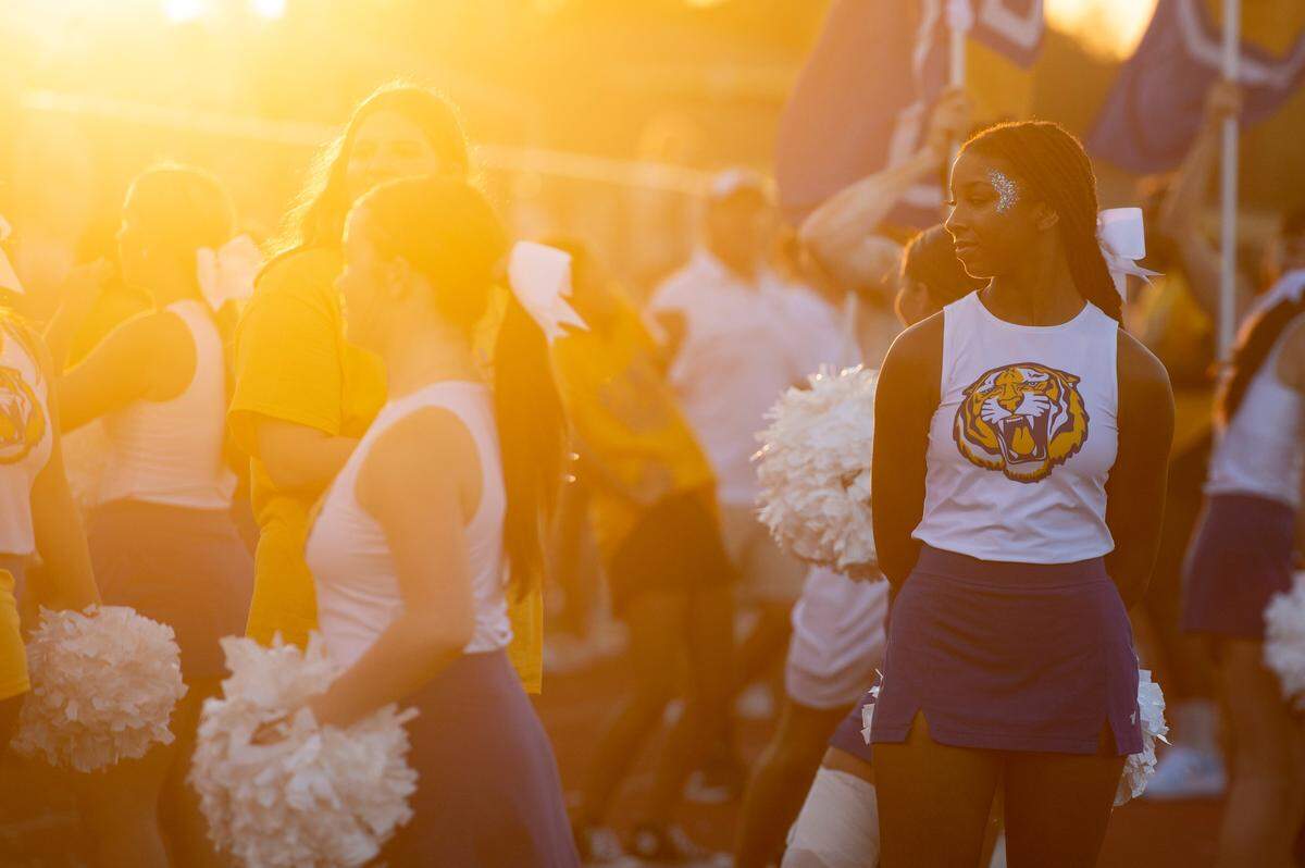 Bay High cheerleaders and alumni cheer on the sidelines at Bay High in Bay St. Louis on Friday, Sept. 1, 2023.