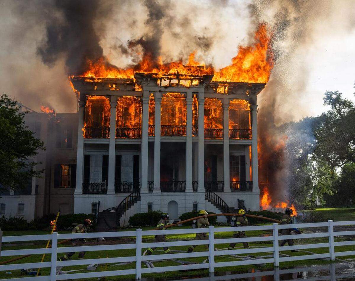 Fire crews mover a line around the fully engulfed the Nottoway Plantation on Thursday, May 15, 2025, in White Castle, Louisiana.