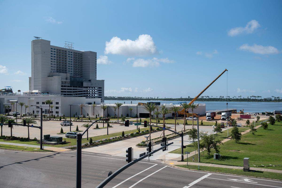 A piece of a new amusement park ride is lifted out of a truck during the assembly of the rides at Paradise Pier Fun Park at Margaritaville Resort in Biloxi on Wednesday, June 1, 2022. Three rides are now in place and 12 more are on the way.