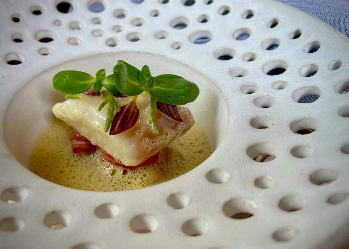 Sous vide cooked red snapper with tomato dashi served at the tasting menu restaurant Vestige in Ocean Springs.