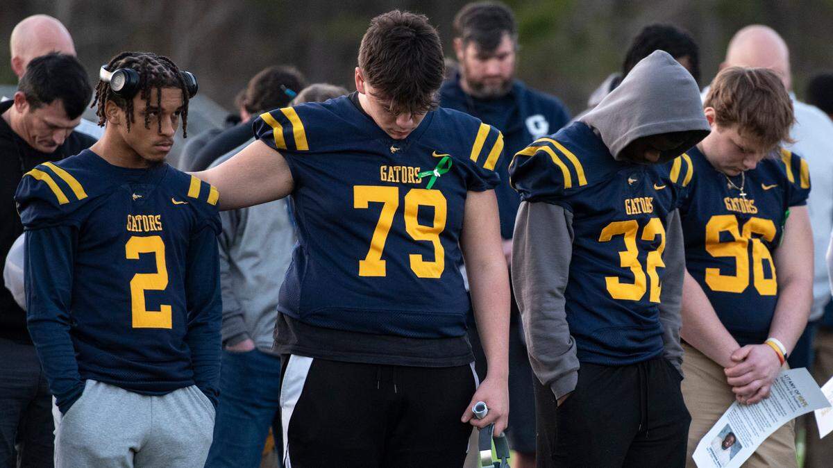Gautier High School football teammates of Shermarion Miner react during a vigil for student Shermarion Miner at Gautier High School on Thursday, Jan. 16, 2025.
