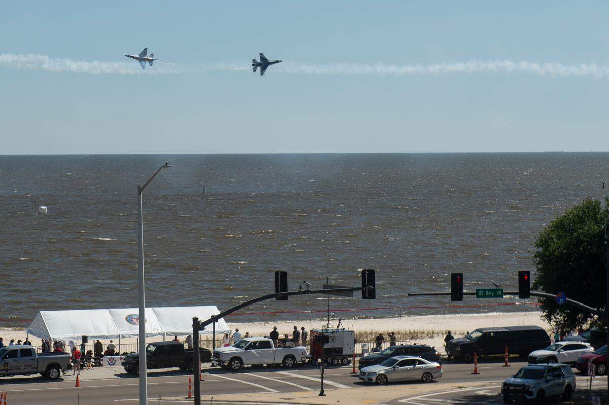 The U.S. Air Force Thunderbirds pass each other over Biloxi Beach during a practice for the Thunder Over the Sound airshow on Friday, April 28, 2023.