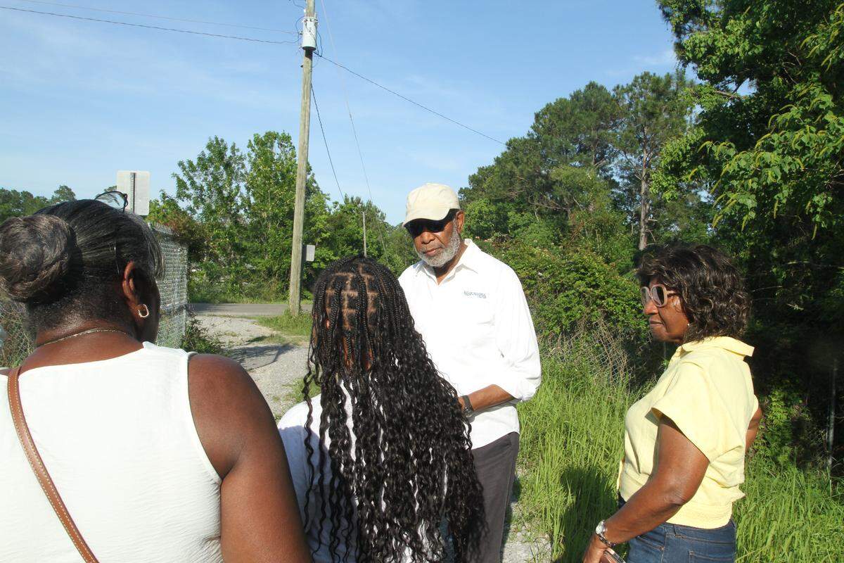 Gulfport resident Glen Cobb visits with neighbors on the Forest Heights flood levee. The residents are concerned about potential flooding from a road the city of Gulfport wants to build through wetlands in the Turkey Creek watershed. The road would open even more wetlands for potential development.