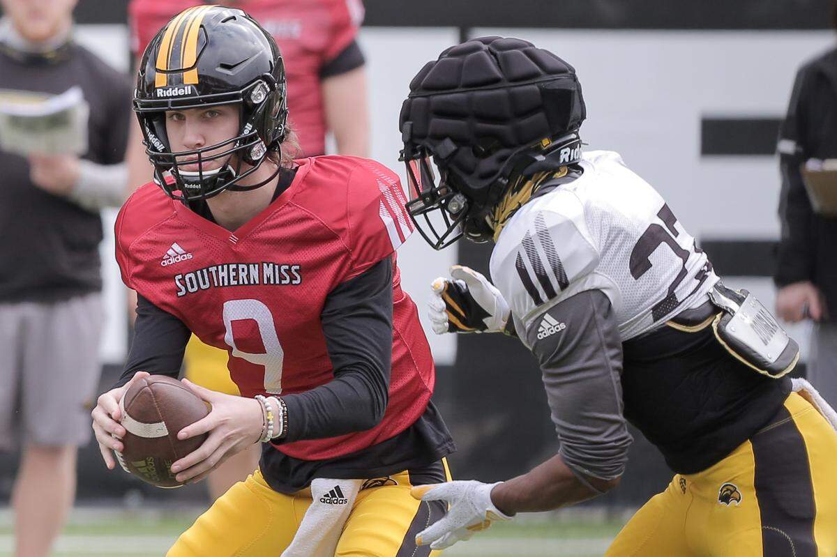 Southern Miss quarterback Tee Webb hands off the football to a Golden Eagle running back during a spring practice at M.M. Roberts Stadium in Hattiesburg.