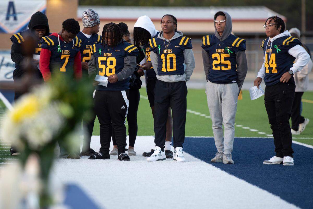 Gautier High School classmates and teammates of Shermarion Miner pray during a vigil for student Shermarion Miner at Gautier High School on Thursday, Jan. 16, 2025.
