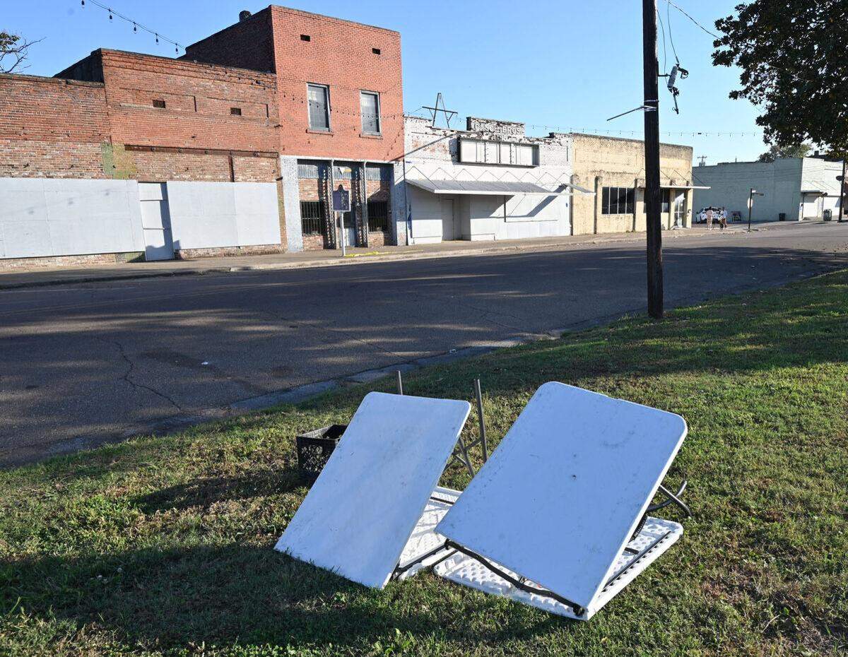 Folding tables and glass littering North Main Street in Leland, Monday, Oct. 13, 2025. A deadly shooting claimed multiple lives during a homecoming celebration this past weekend.