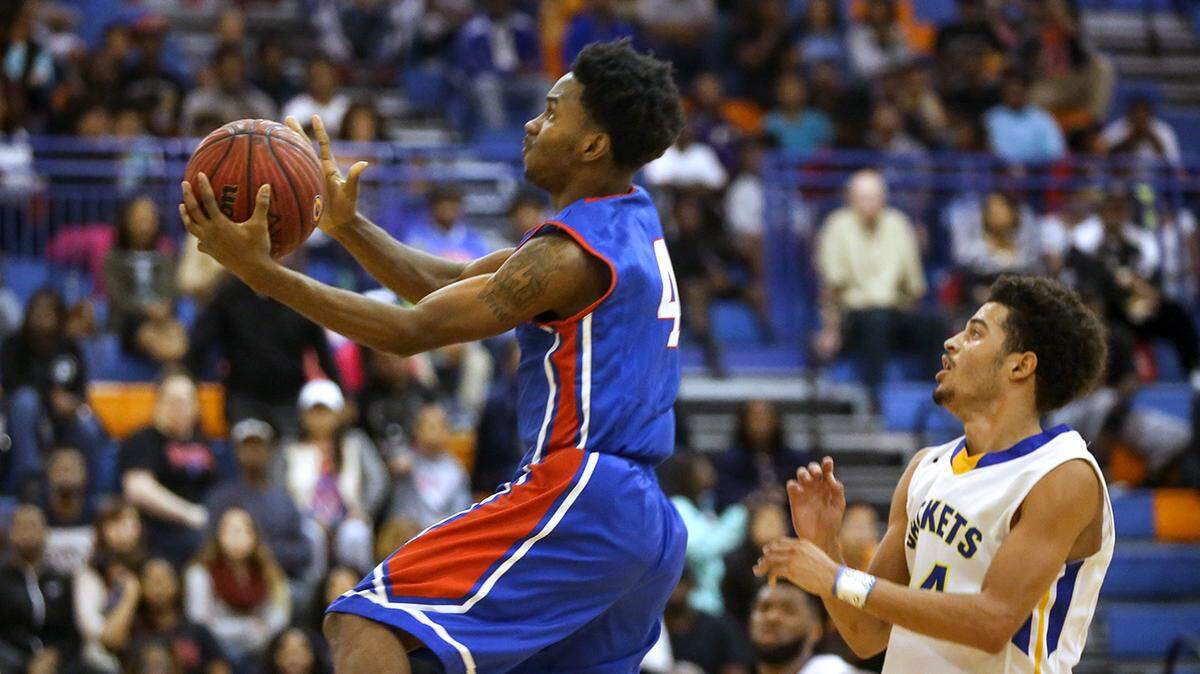 AMANDA McCOY/SUN HERALD 
 Pascagoula's Anthony McMillian bounds past St. Martin's Stacee St. Julian while driving to the basket during the Admirals Hardwood Holiday Classic last Monday. Pascagoula defeated St. Martin in overtime, 71-70.