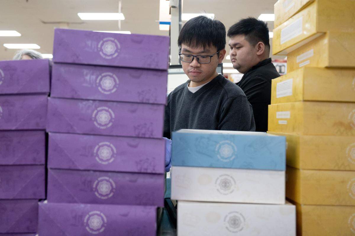 Employees stack boxes of Dong Phuong king cakes at Lee’s International Market in Biloxi on Jan. 9, 2026.