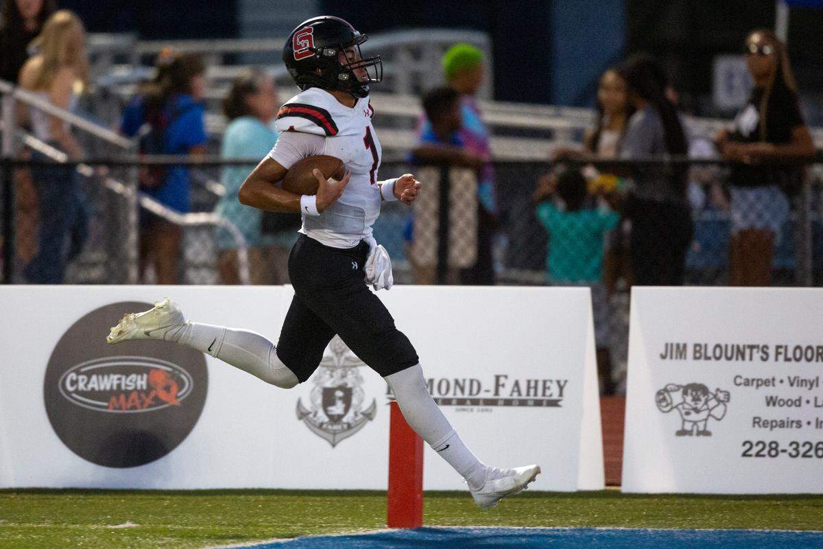 St. Stanislaus quarterback Ian Gael Gonzalez Rioz runs the ball into the end zone for a touchdown during a game at Bay High in Bay St. Louis on Friday, Sept. 1, 2023.
