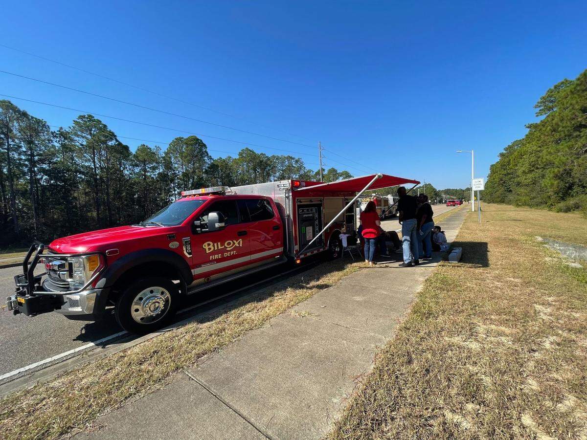 Biloxi school teachers gather in the shade while Biloxi police special response teams search Biloxi Jr. High and nearby schools for any threat. Students were out of school Friday.