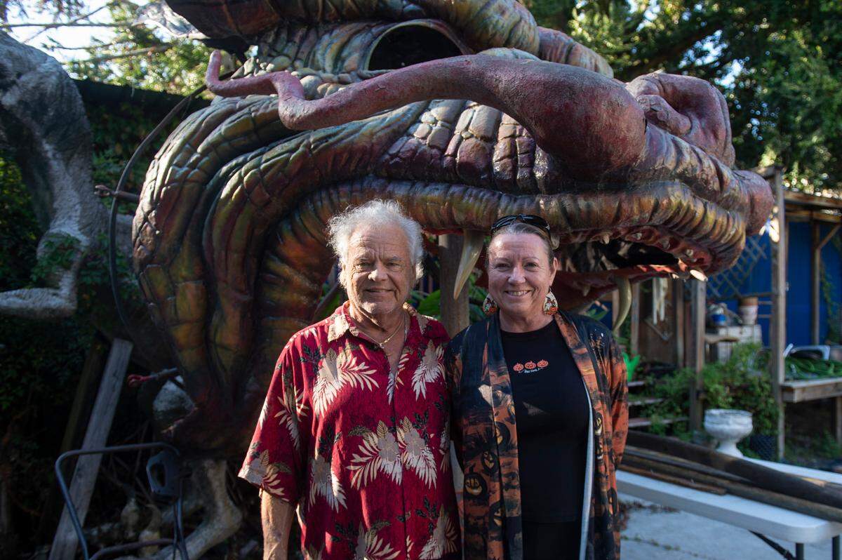 Frank and Marlene Gann stand in front of the Lady Luck Casino dragon in their backyard on Tuesday, Oct. 17, 2023. The Ganns rescued the dragon from being trashed when the Lady Luck Casino closed in the late 90s.