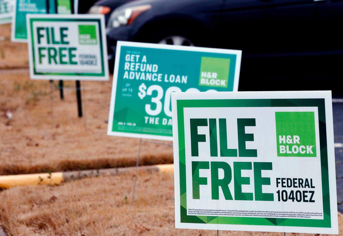 FILE- In this Feb. 14, 2018, file photo, H&R Block signs are displayed in Jackson, Miss. Congressional Democrats are accusing big tax preparation firms including Intuit and H&R Block of undermining the federal government’s upcoming electronic free-file tax return system, and are demanding lobbying, hiring and revenue data to determine what’s going on. (AP Photo/Rogelio V. Solis, File)