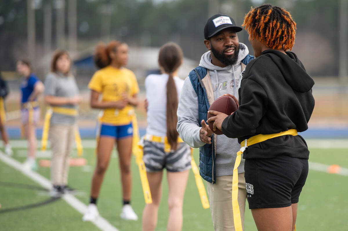 Assistant coaches work with St. Martin High School students as they try out for the inaugural flag football team at St. Martin High School on Tuesday, Feb. 18, 2025.