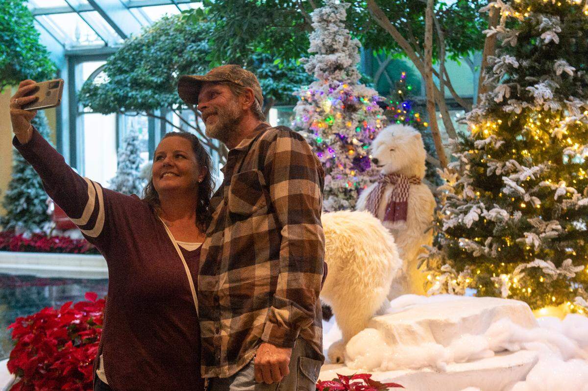 Christina Gilliand and James Shipp, of Lucedale, take a photo in front of a Christmas display at the Beau Rivage Casino in Biloxi on Thursday, Dec. 1, 2022.