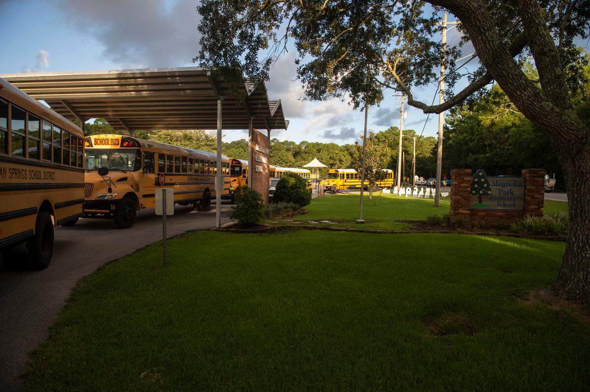 Buses line up outside Magnolia Park Elementary School before letting kids off on the first day of school in Ocean Springs on Friday, Aug. 5, 2022.