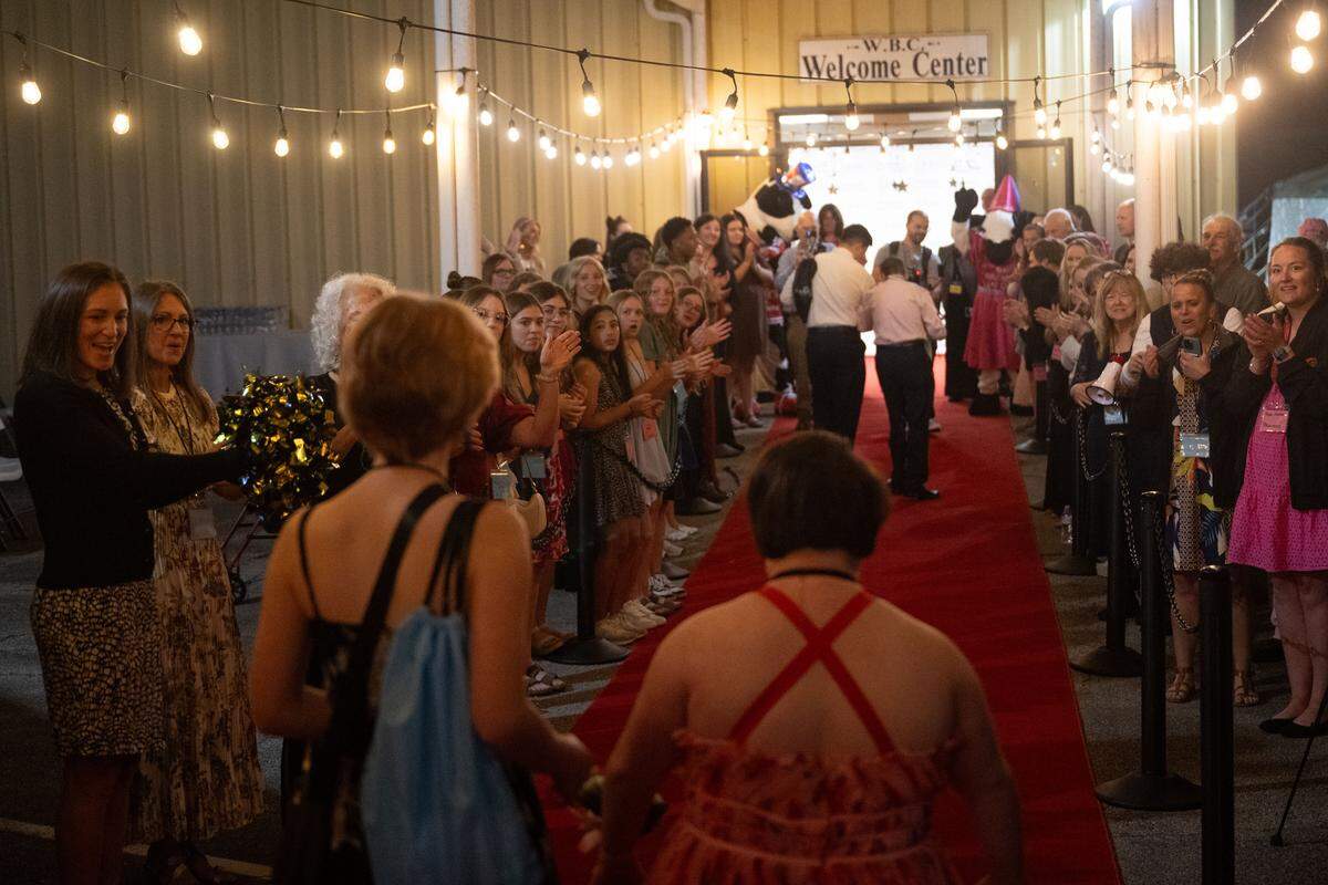 Guests of honor walk the red carpet during Night to Shine at Woolmarket Baptist Church on Friday, Feb. 13, 2026.