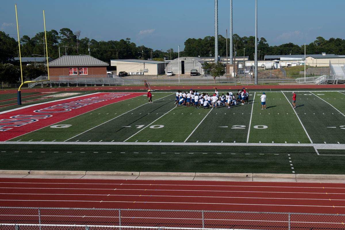 Pass Christian football players huddle during practice at Francis McDonald Stadium in Pass Christian on Tuesday, Aug. 1, 2023.