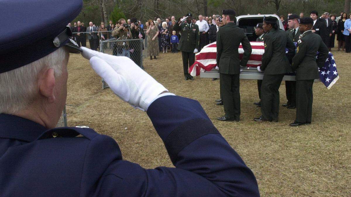 SUN HERALD/FILE 
 Maj. Gen. Harold Cross salutes the coffin of Sgt. 1st Class Michael Sean Cooley as military personnel, friends, family and members of the Benndale community in George County attended Cooley's graveside funeral services. A Mississippi National Guard soldier, Sgt. Cooley was killed in Iraq.