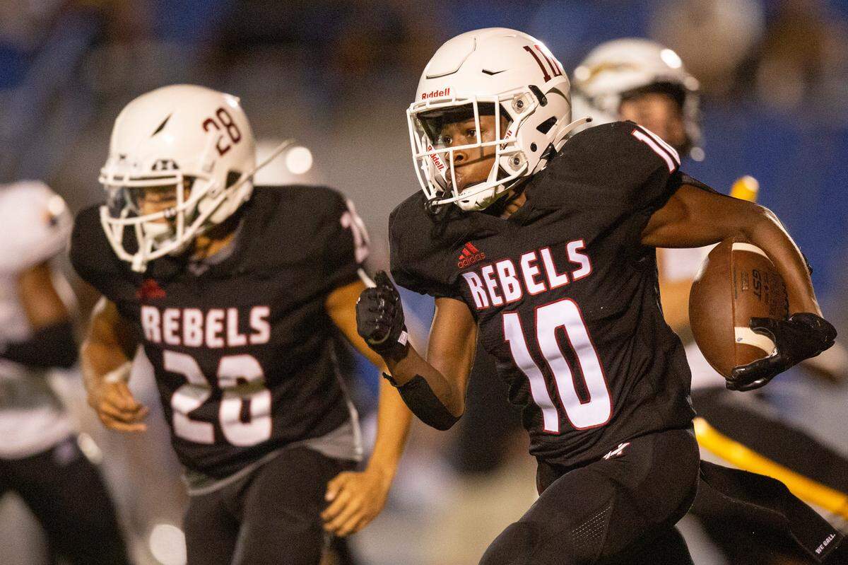 Harrison Central’s Tyree Barnett (#10) runs the ball during a game against Oak Grove at Milner Stadium in Gulfport on Friday, Aug. 26, 2022.