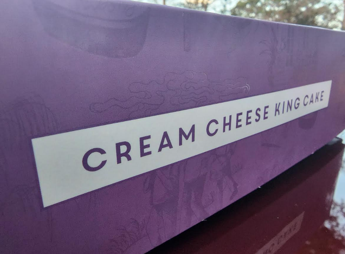 A purple bakery box from Dong Phuong Bakery is labeled cream cheese king cake.