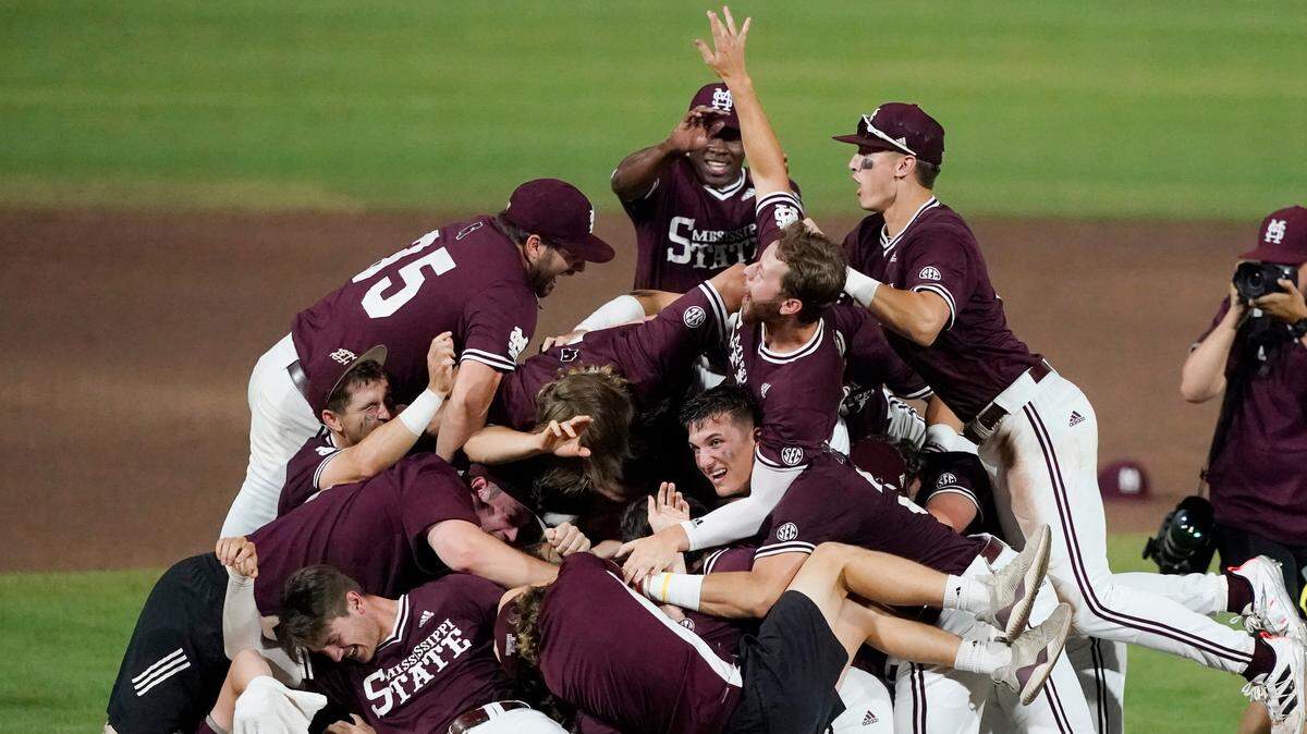 Mississippi State players and coaches celebrate their win over Notre Dame at an NCAA college baseball super regional game, Monday, June 14, 2021, in Starkville, Miss. (AP Photo/Rogelio V. Solis)
