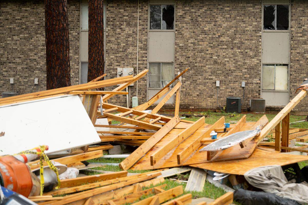 Debris and the broken windows of apartments are seen Sunday at the Riverbend Condos in Gautier.