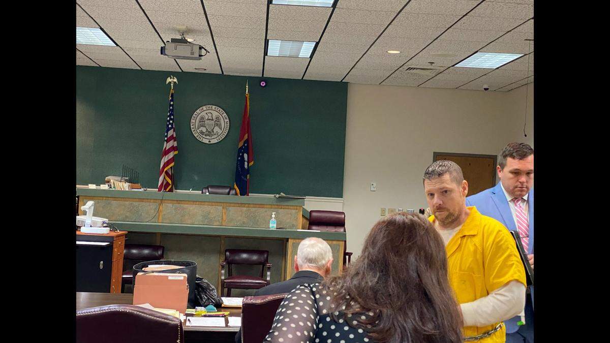 Jacob Blair Scott, 45, talks to his mother, Melody Scott, prior to him taking a seat in Jackson County Circuit Court on Wednesday, April 6, 2022.