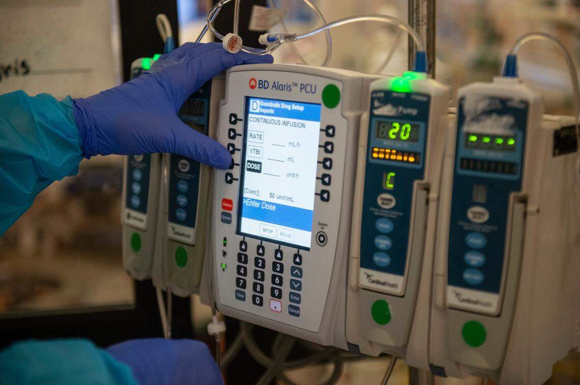 ICU nurse Jen Sartin changes settings on a patient’s IV inside the ICU at Singing River Health System hospital in Ocean Springs on Tuesday, July 27, 2021.