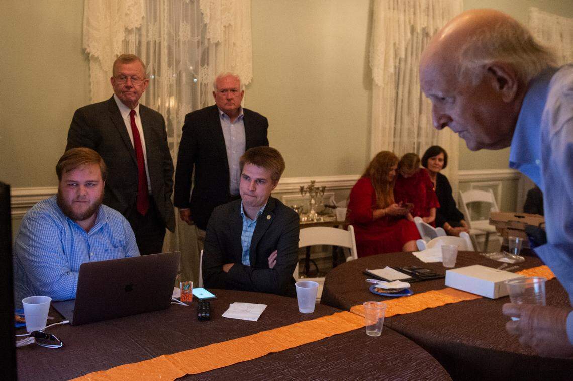 Friends and campaign members of Jackson County Sheriff Mike Ezell, the Republican candidate for Mississippi’s 4th Congressional District, sit around a television as results come in on election night at Grand Magnolia Ballroom and Suites in Pascagoula on Tuesday, Nov. 8, 2022.