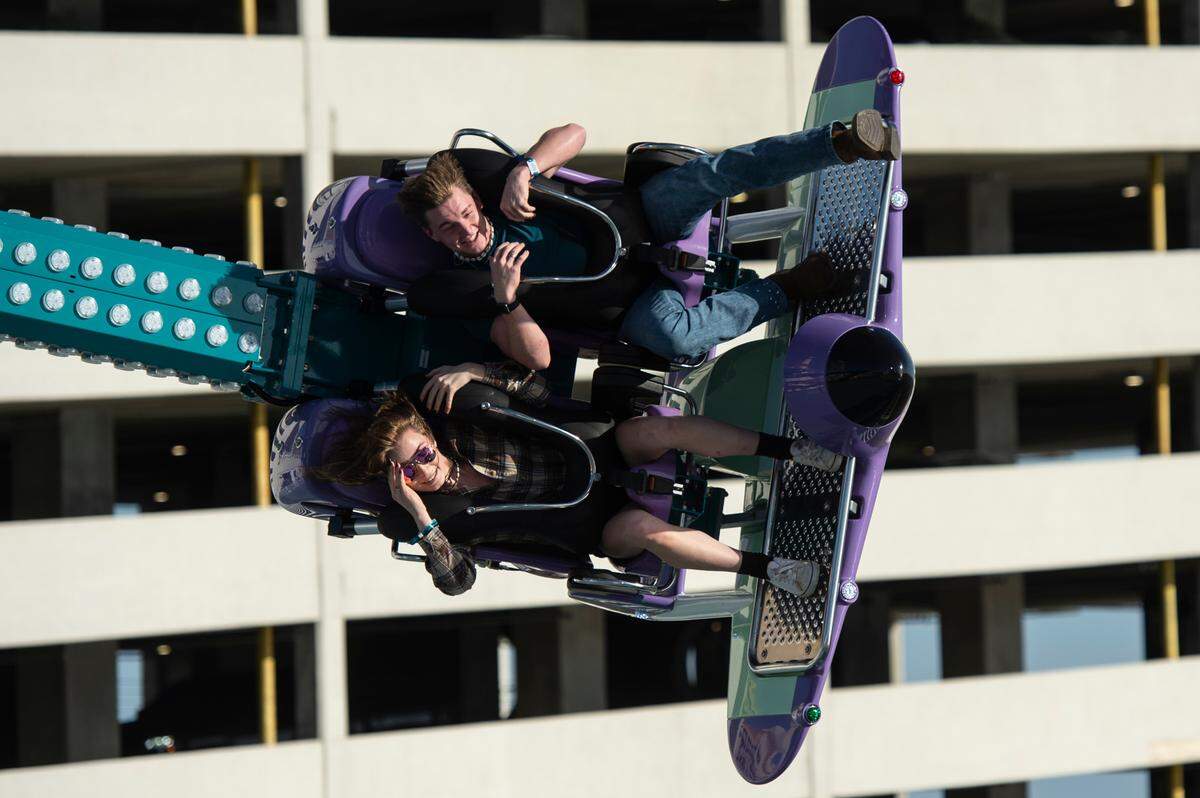 Riders react as they ride the Puddle Jumper ride during the grand opening of Paradise Pier amusement park at Margaritaville in Biloxi on Friday, March 3, 2023.