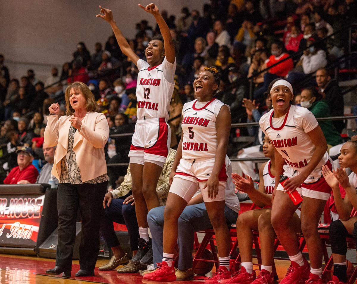 From left, Harrison Central’s Head Coach Nancy Ladner, Laila Walker, Khyla Ragins, and Hanna Travis cheer on their teammates from the sidelines during a game against Gulfport at Harrison Central High School in Gulfport on Friday, Feb. 4, 2022.