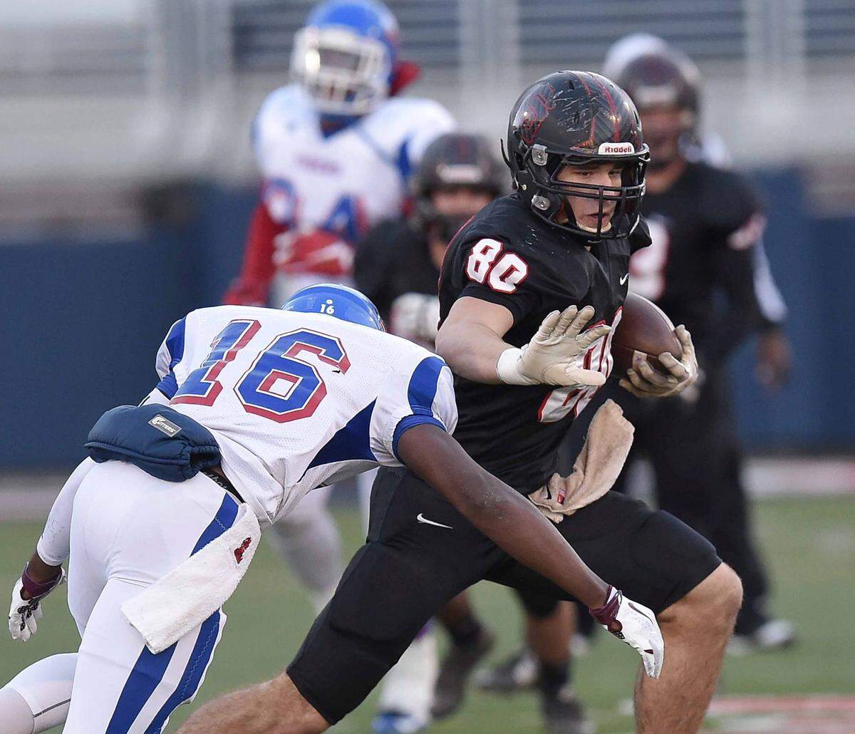 St. Stanislaus receiver Chase Rogers (80) uses a stiff arm against Noxubee County defender Daveon Ball (16) on Saturday, December 5, 2015, in the MHSAA Class 4A State Football Championship in Vaught-Hemmingway Stadium on the Ole Miss campus in Oxford, Miss.