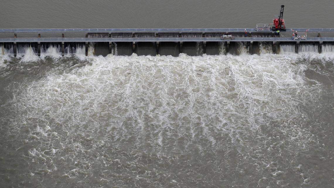 Workers in May open bays of the Bonnet Carré Spillway to divert rising water from the Mississippi River to Lake Pontchartrain, upriver from New Orleans, in Norco, Louisiana. This was the first time the spillway has opened twice in one year, with the earlier opening in February. From the lake, the river water flows into the Mississippi Sound.