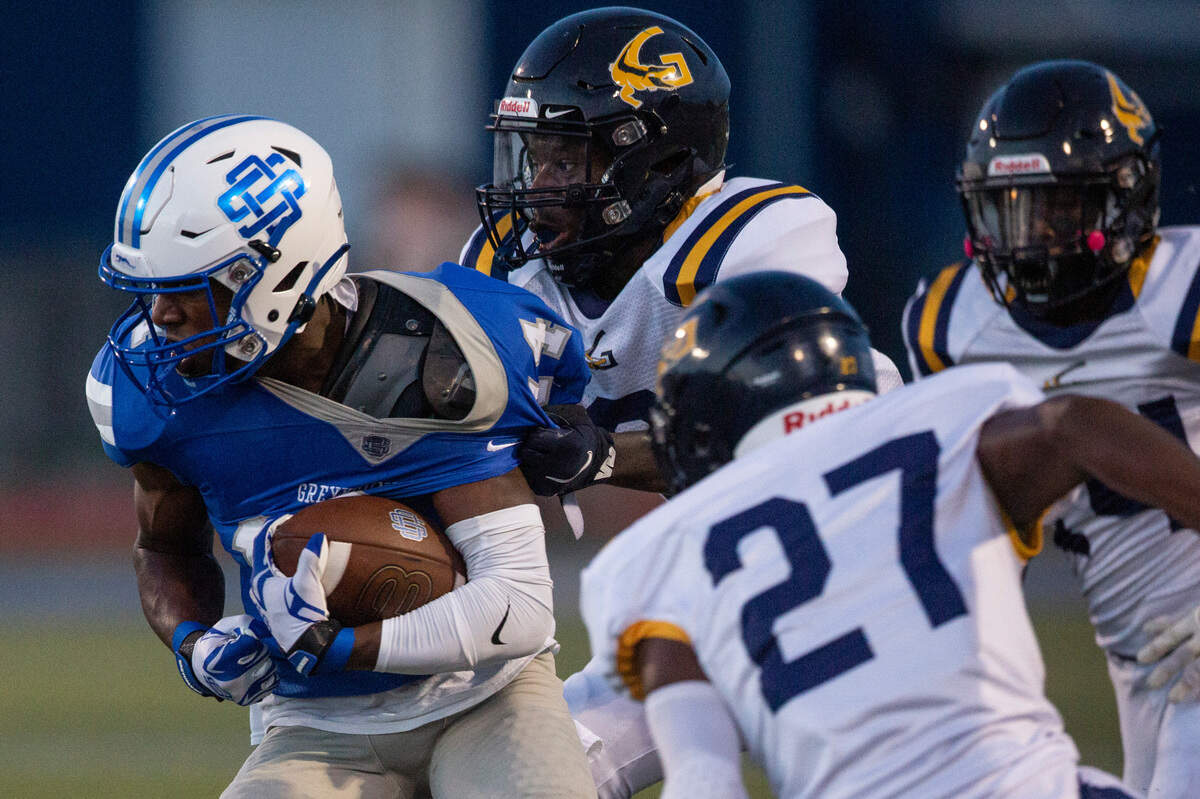 Ocean Springs’ J.P. Coulter gets tackled by Gautier during a Jamboree game at Greyhound Stadium in Ocean Springs on Friday, Aug. 19, 2022.