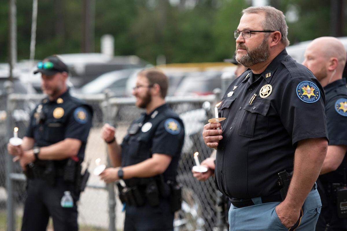 Harrison County Sheriff’s deputies that searched for Gracelyn Vick when she was missing attend a candlelight vigil in remembrance of Vick at Saucier Park on Tuesday, April 22, 2025.