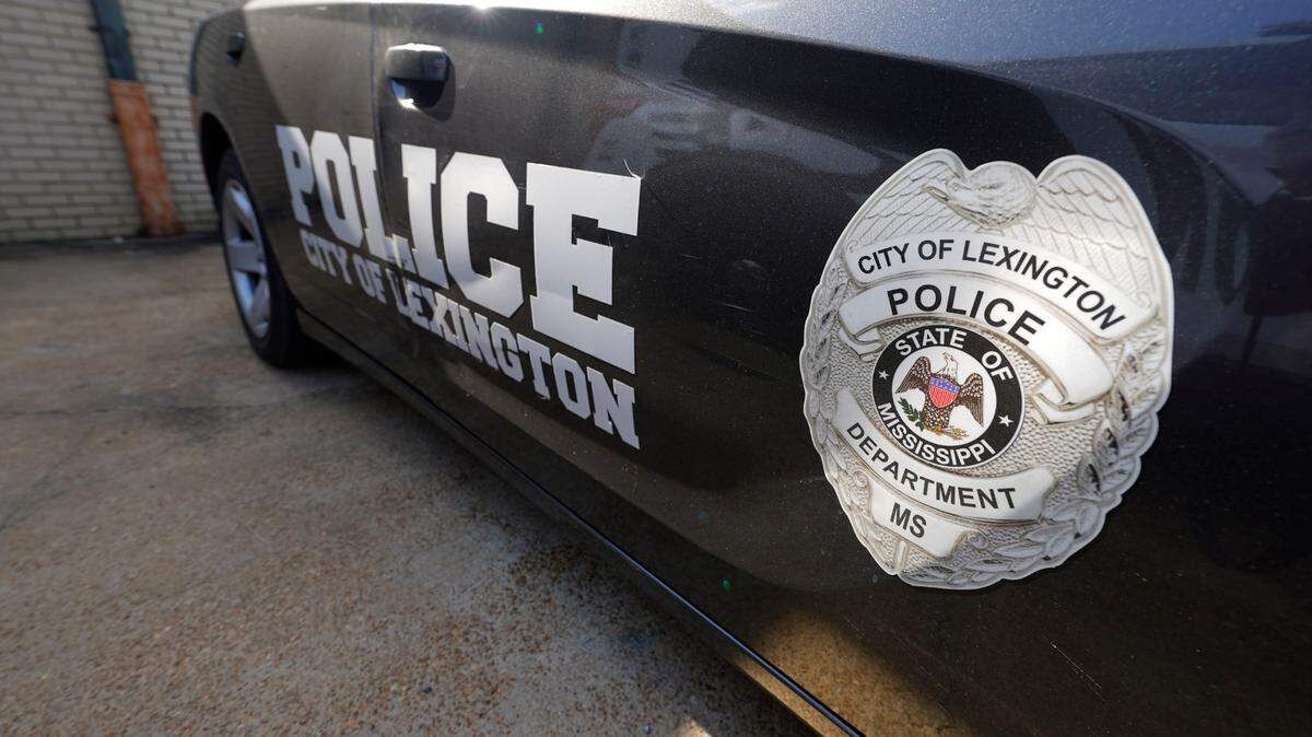 A Lexington police cruiser is parked outside their facility near the town square. The Lexington police department unconstitutionally jailed people for unpaid fines without first assessing whether they could afford to pay them, the U.S. Department of Justice said Thursday.