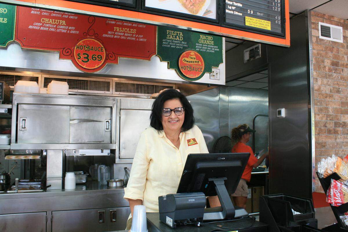 Vicki Parkhill, wife of 28 years to her late husband Lynn, stands behind the register at Gulfport’s Taco Sombrero.