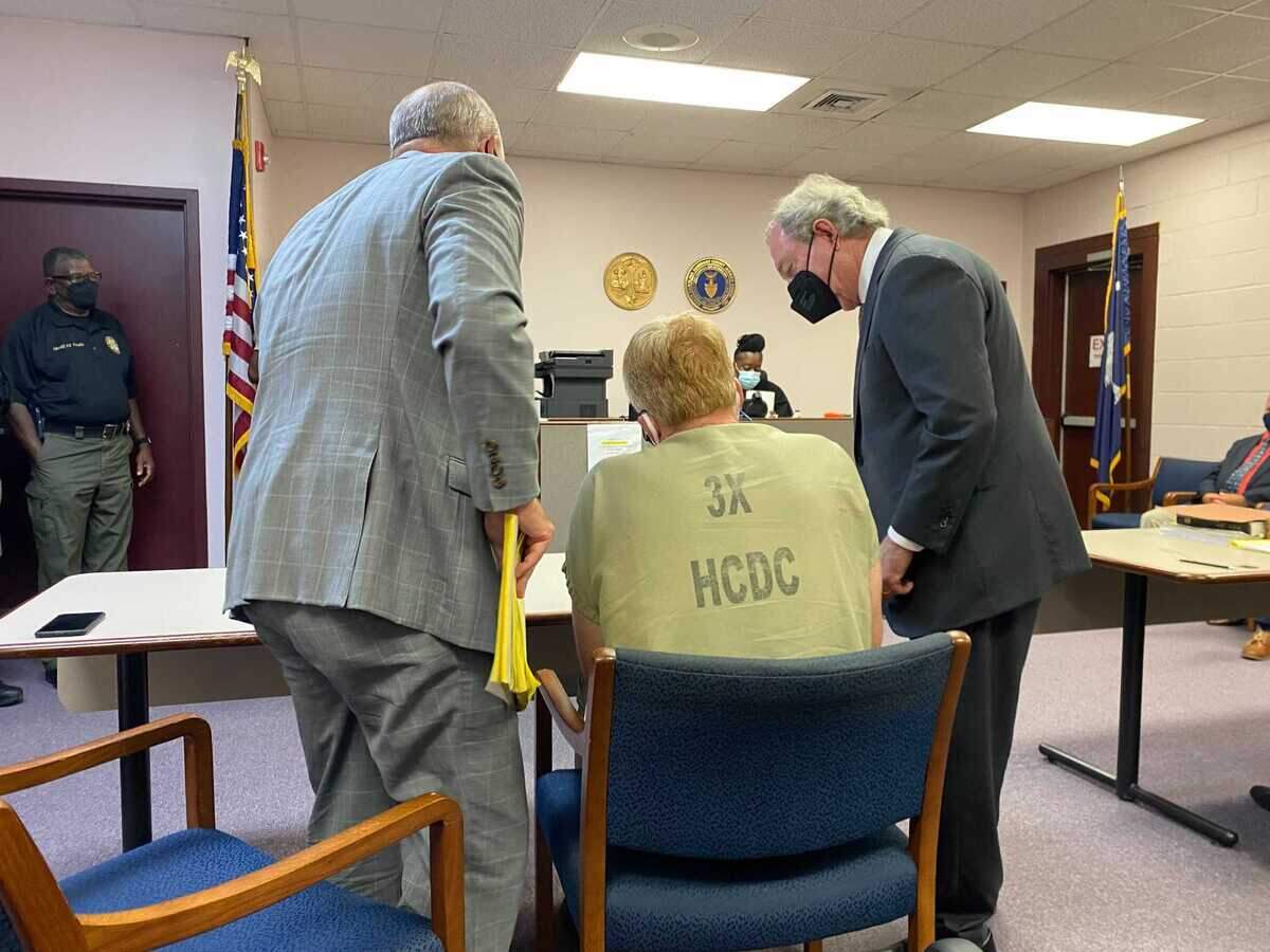Attorneys Jim Griffin, left, and Dick Harpootlian, right, speak with client Alex Murdaugh and a Hampton County bond hearing on Thursday, Sept. 16, 2021.