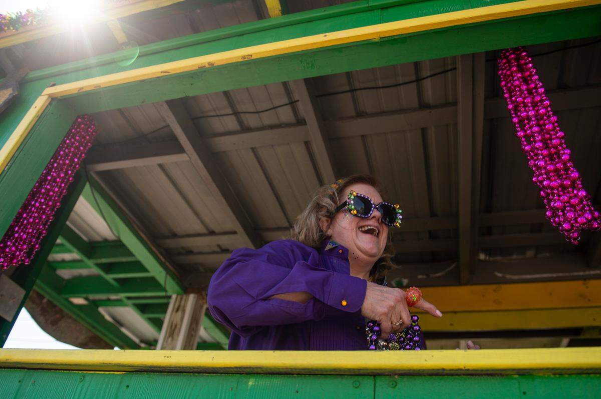 Krewes toss beads and other throws during the Jackson County Carnival Association Mardi Gras parade in Pascagoula on Saturday, March 1, 2025.