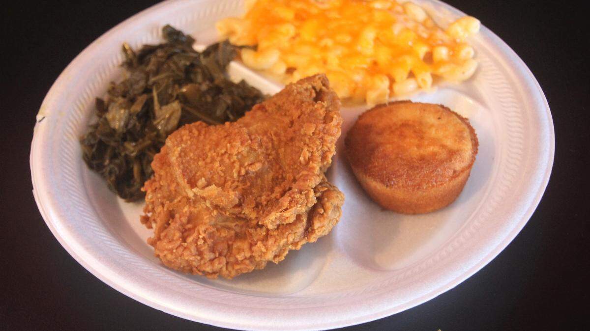 Fried chicken plate with mac and cheese and greens at Big Daddy’s soul food restaurant in Gulfport.