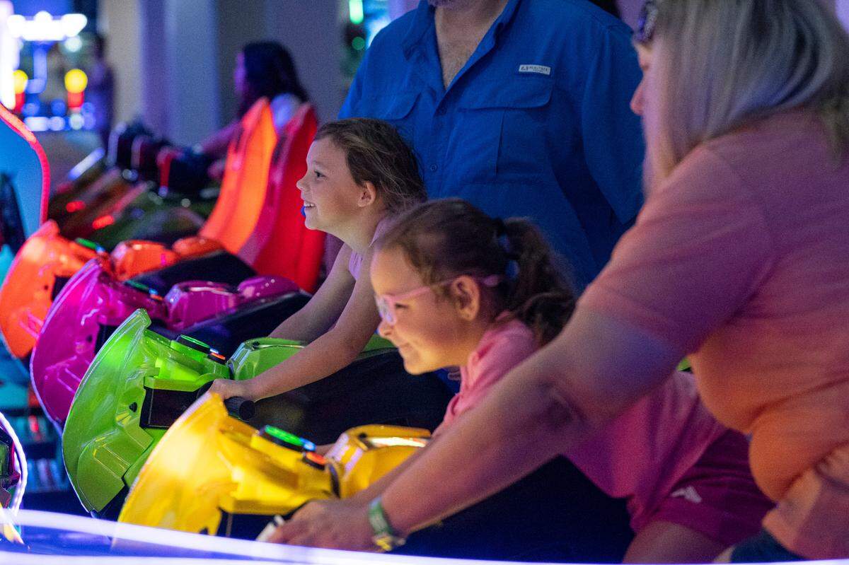 Visitors play arcade games at Hippie Fish at Centennial Plaza in Gulfport on Thursday, June 26, 2025.