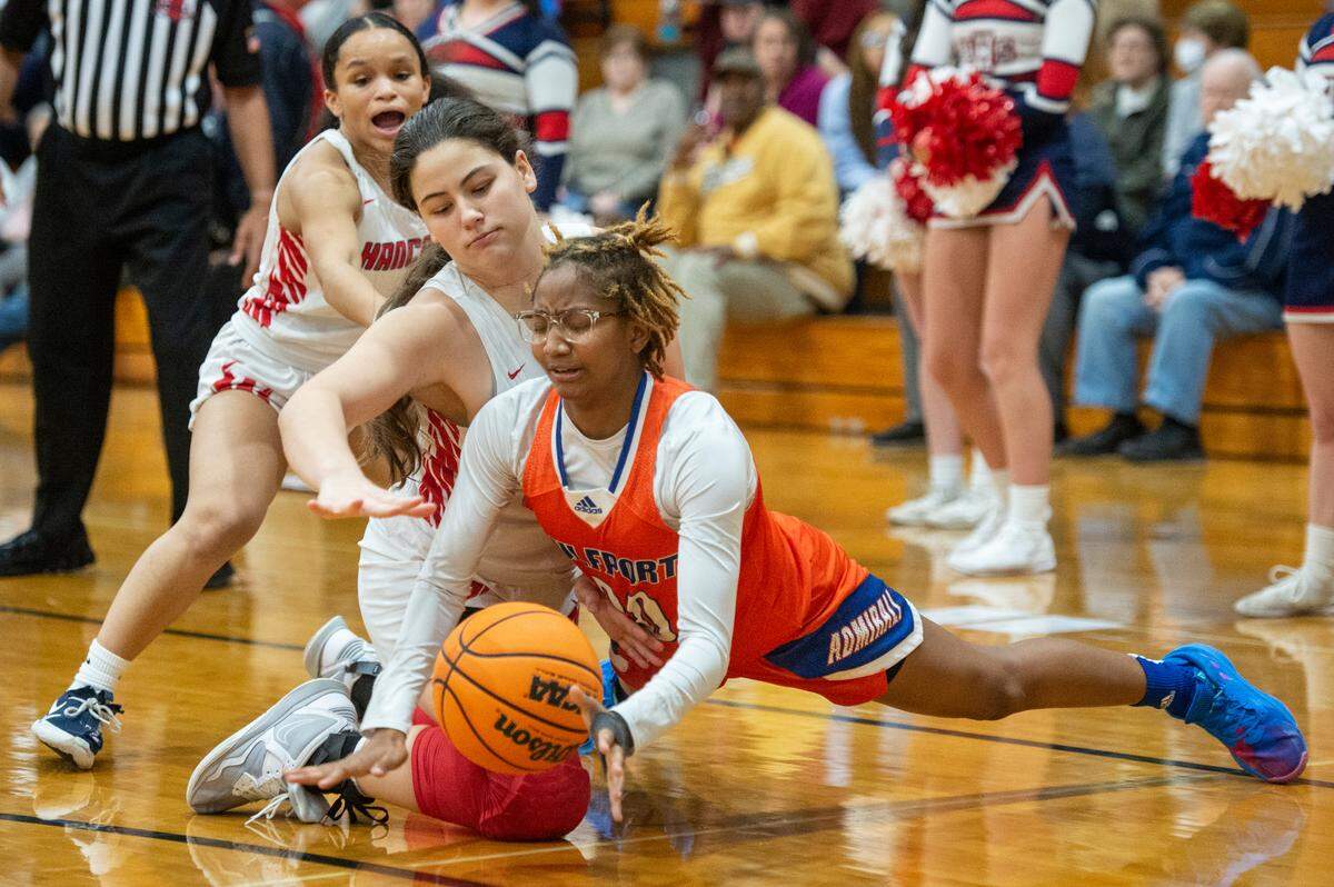 Hancock’s Talana Bond, Riley Bishop, and Gulfport’s DeAsia Bradley fight for the ball during a game against Gulfport at Hancock High School in Kiln on Tuesday, Jan. 10, 2023.