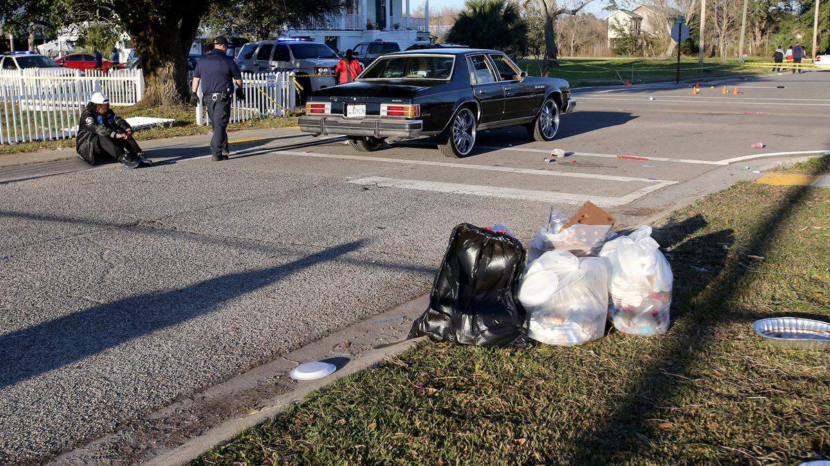 AMANDA McCOY/SUN HERALDA black Buick at the scene of a shooting that left two dead and four taken to the hospital remains roped off as law enforcement investigate on Sunday. The shooting occurred on Davis Avenue after the St. Paul Carnival Association Mardi Gras.